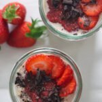 Two glass jars filled with peanut butter and jelly overnight oats.