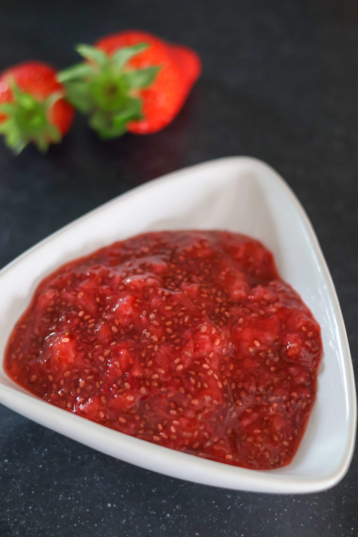 Strawberry chia jelly in a white bowl.