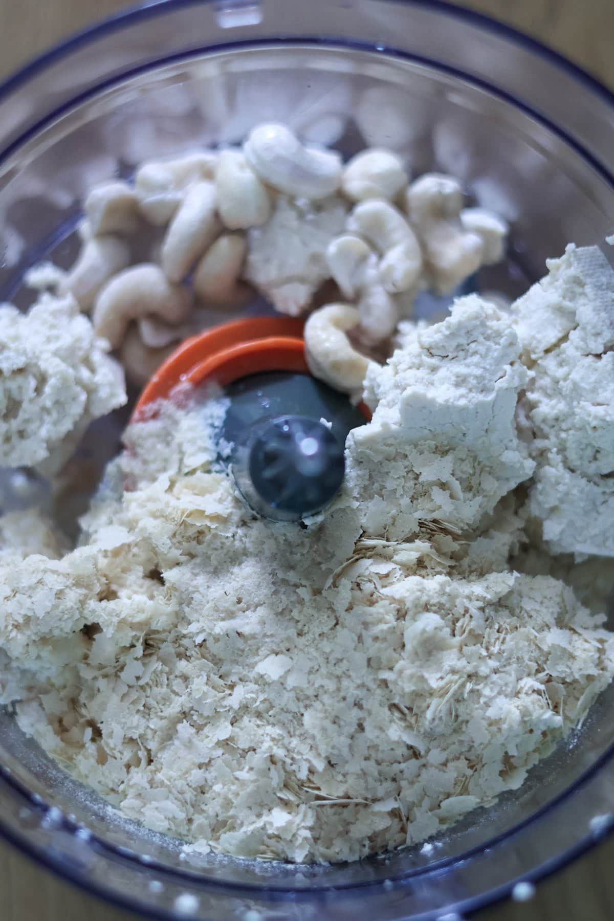 Raw cashews, nutritional yeast, tofu, lemon juice and salt in a food processor.
