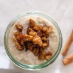 One jar filled with cinnamon roll overnight oats with caramelized walnuts.