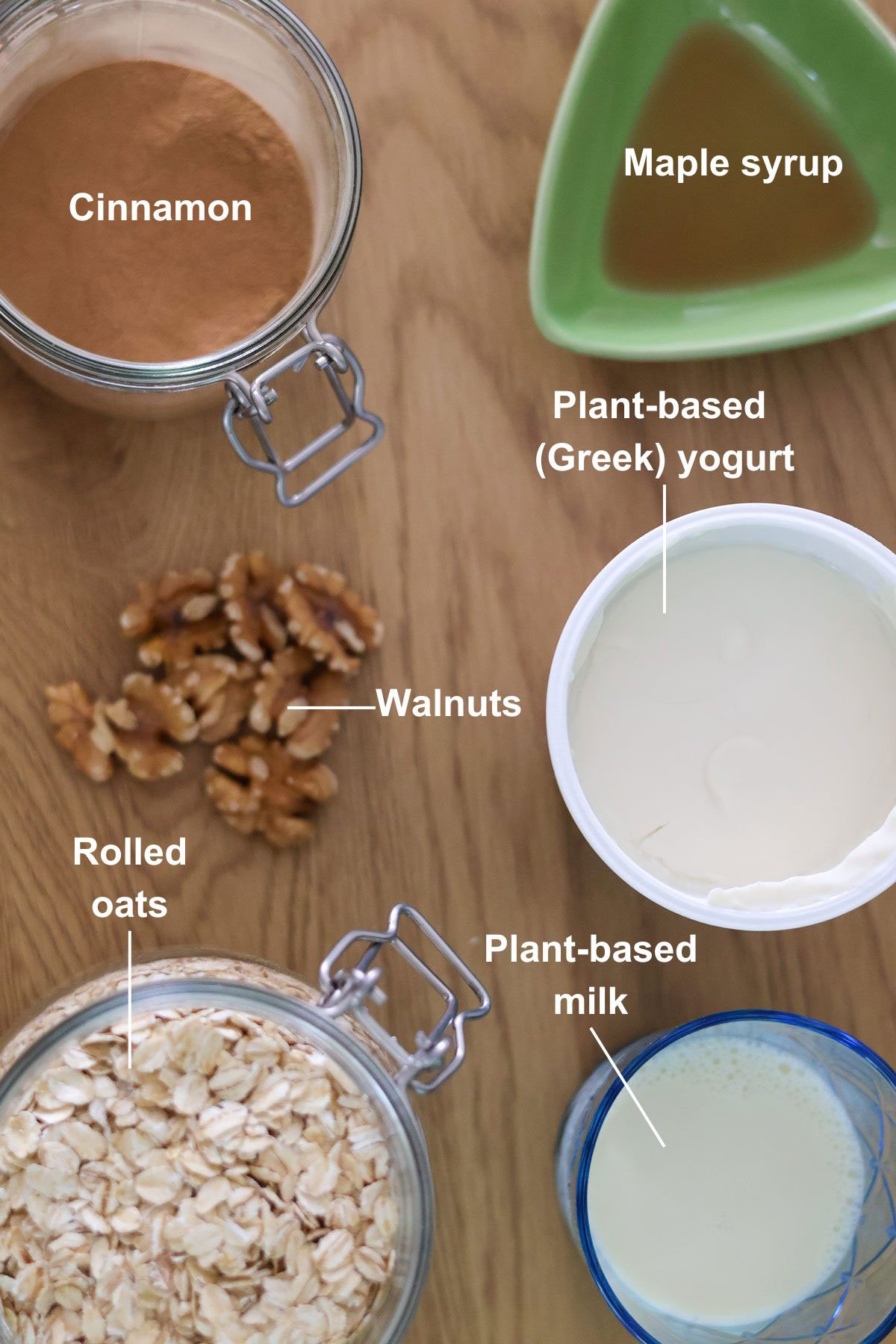 The ingredients for the cinnamon roll overnight oats recipe on a wooden table.