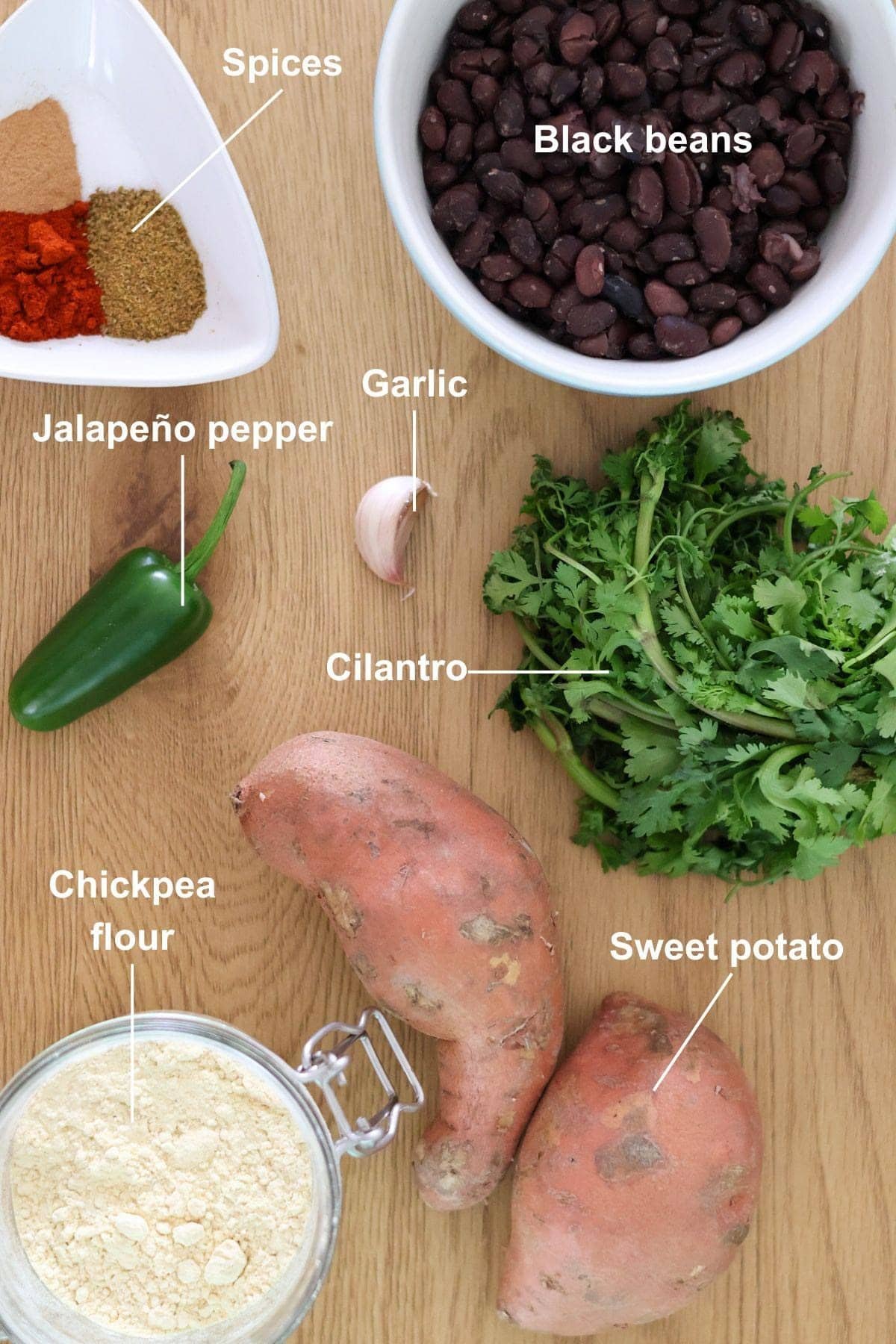 The ingredients for the healthy vegan sweet potato cakes on a wooden table.