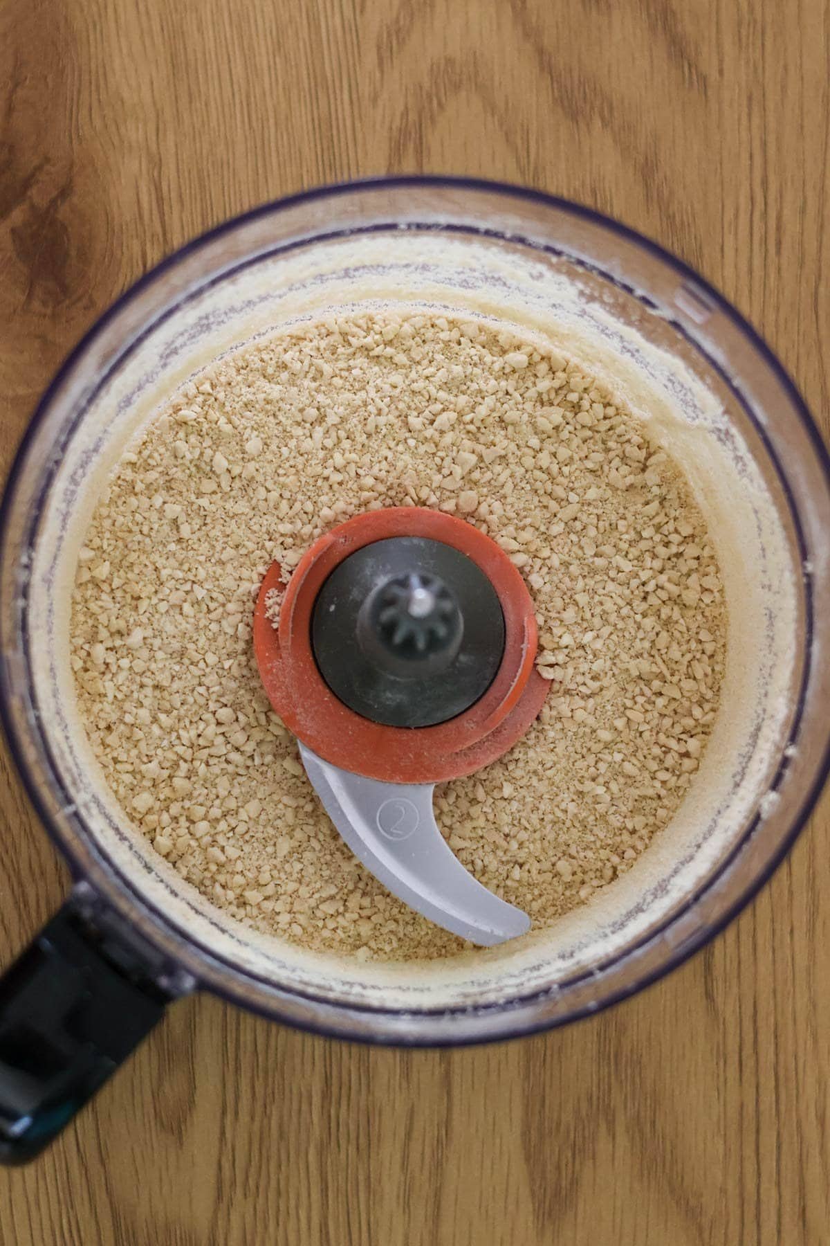 the ingredients for the vegan parmesan cheese recipe are ground in a food processor.