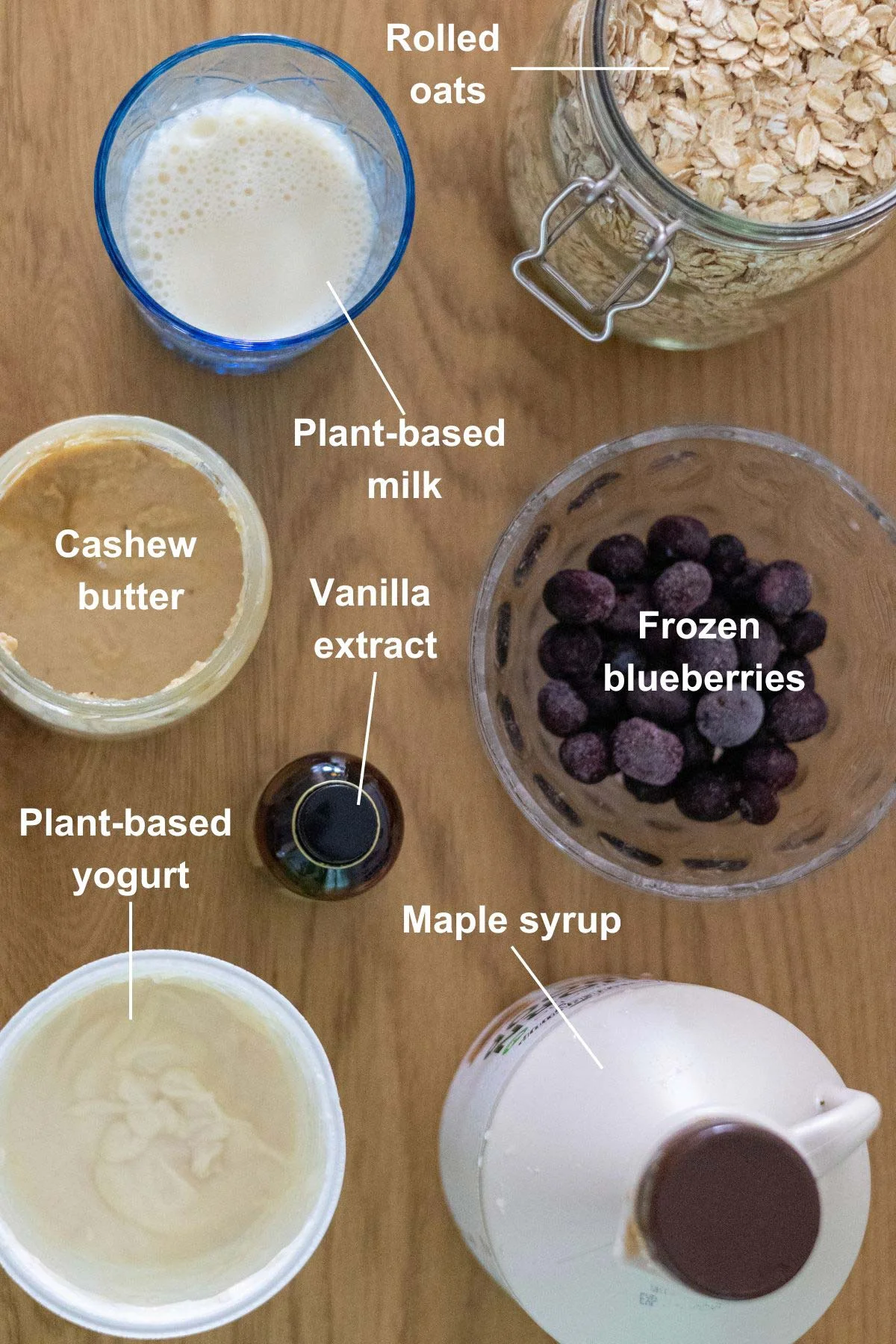 The ingredients for the blueberry cheesecake overnight oats recipe on a wooden table.