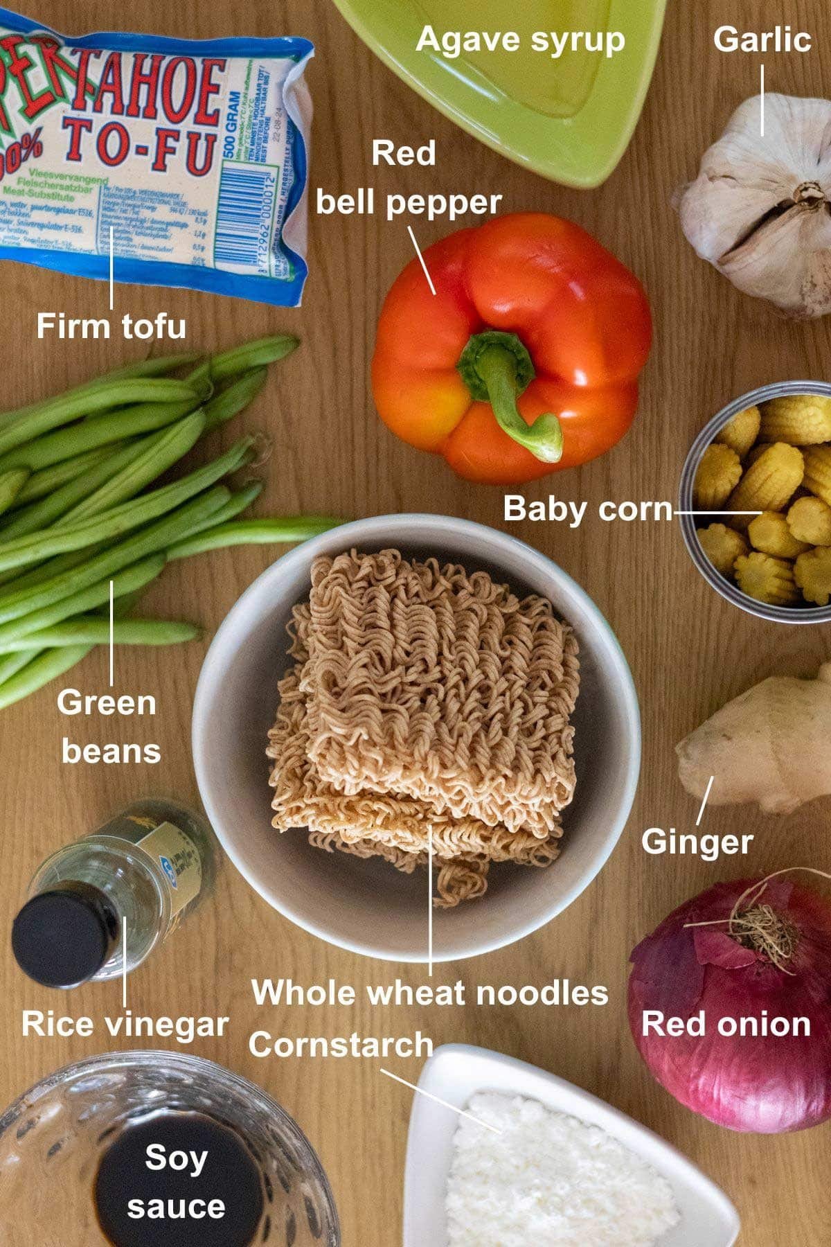 All the ingredients for the Vegan Teriyaki Tofu Stir-Fry recipe on a wooden table.