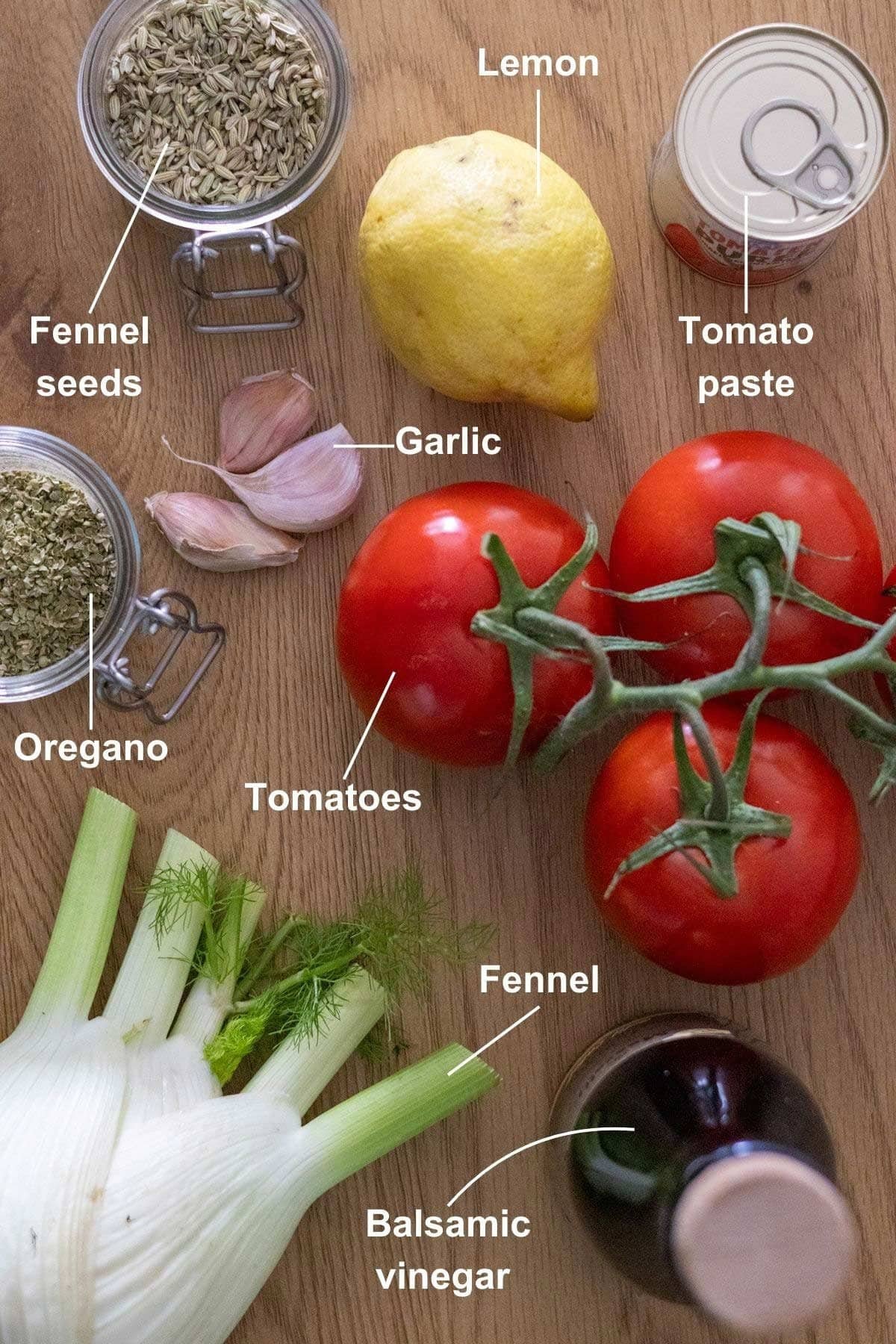 All the ingredients for the Tomato and Fennel Soup on a wooden table.