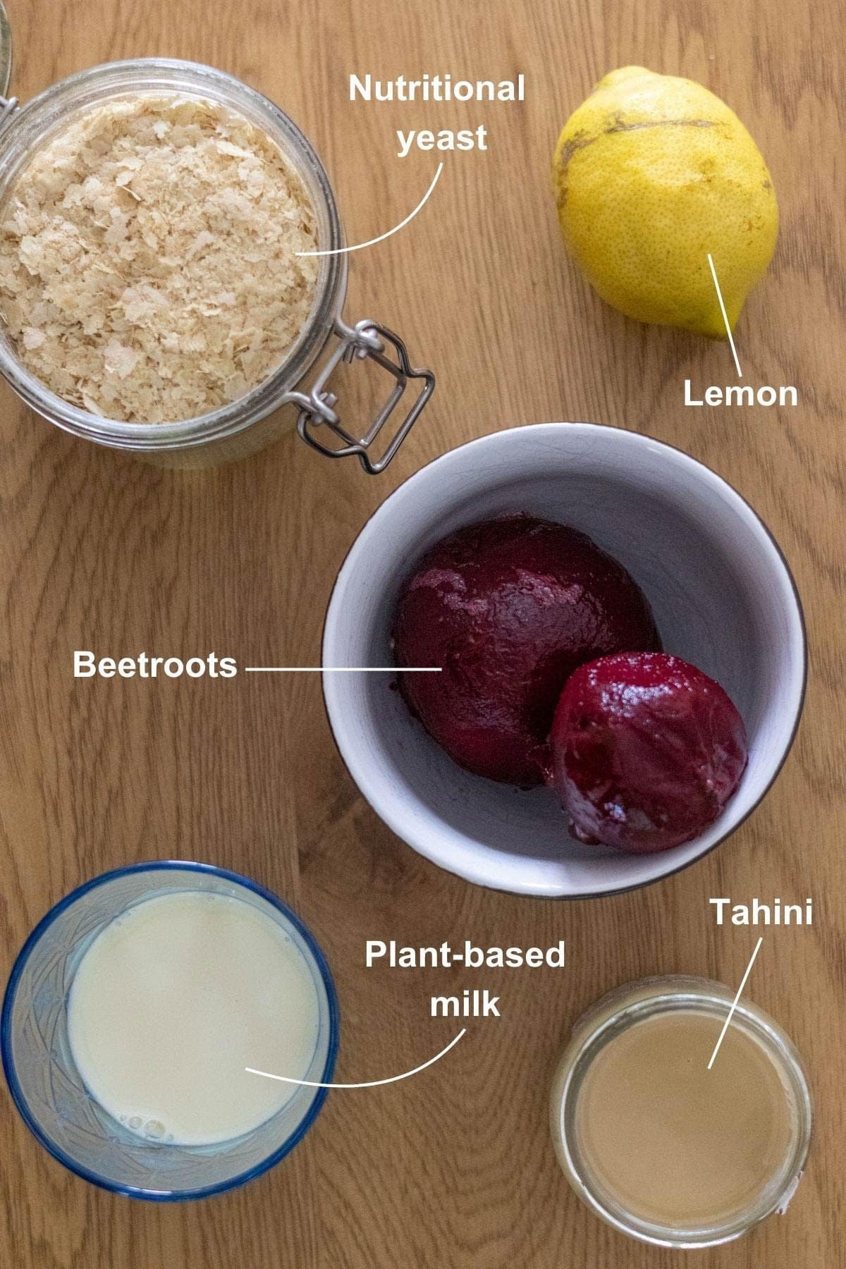 All the ingredients for the beetroot pasta sauce on a wooden table.